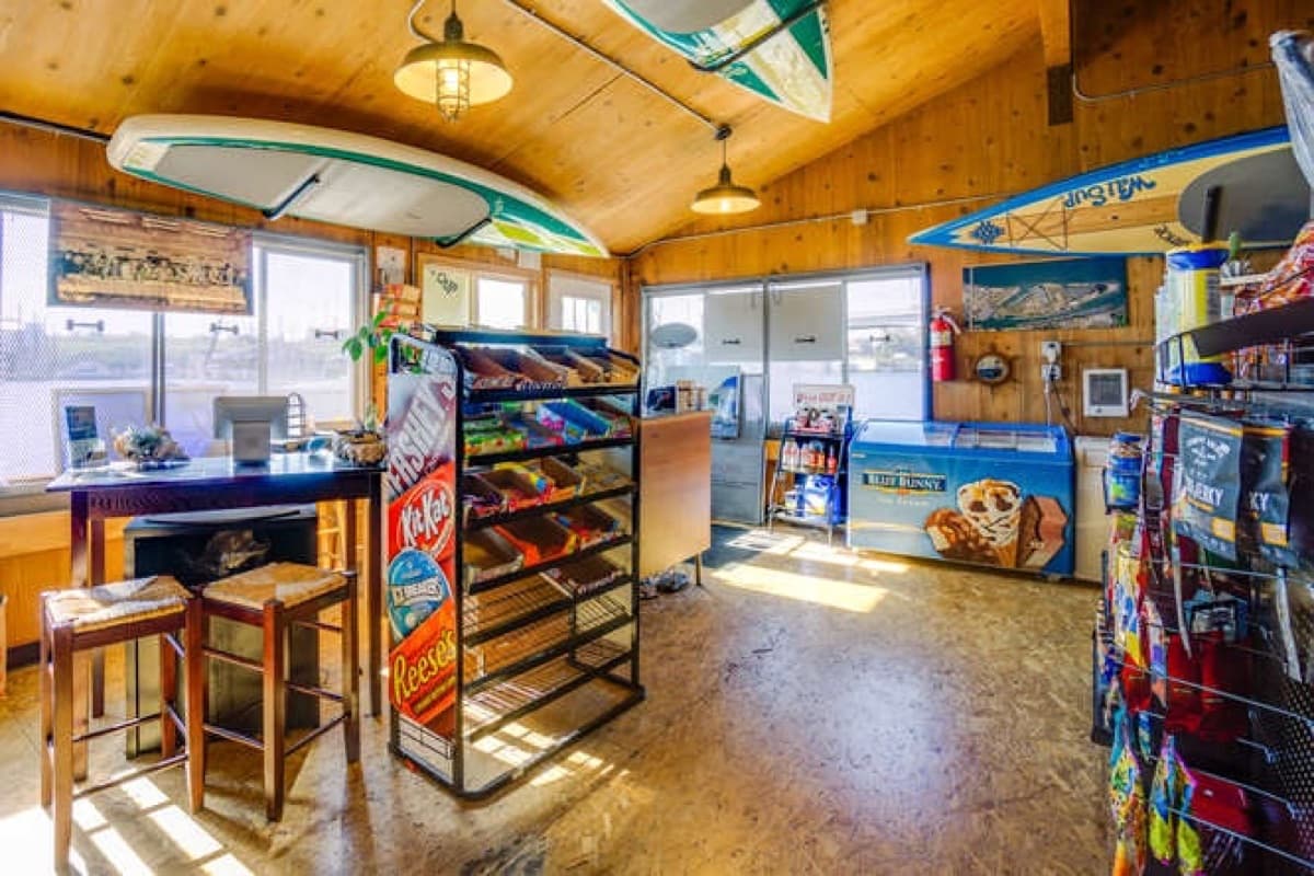 Inside the Jantzen Fuel Depot store — snacks, drinks, and paddleboards hung from the ceiling